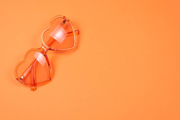 istock Summer hat lay on pink hair on orange background. 1206855184