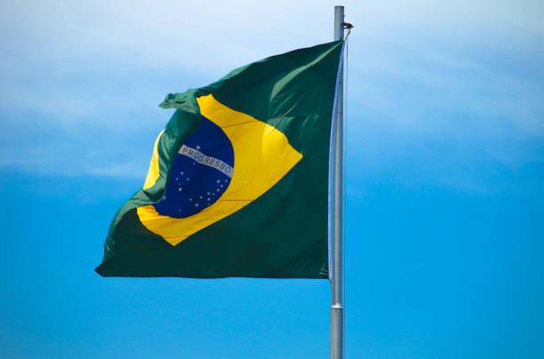 istock Brazilian flag in a blue sky 1206855332