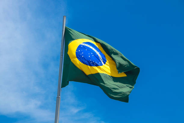 istock Brazilian flag in a blue sky 1206855351