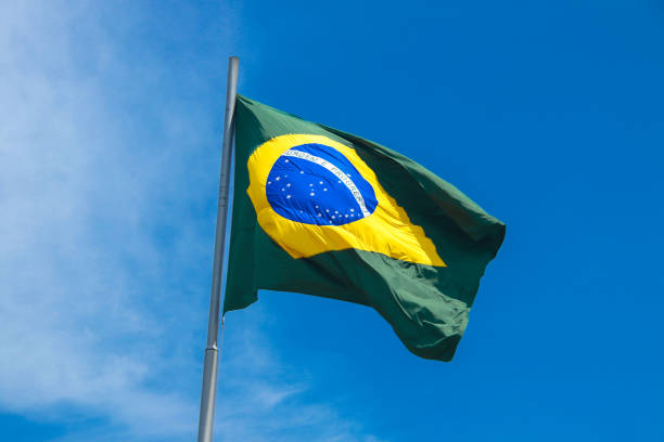 istock Brazilian flag in a blue sky 1206855367