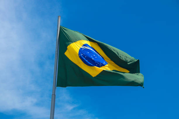 istock Brazilian flag in a blue sky 1206855391