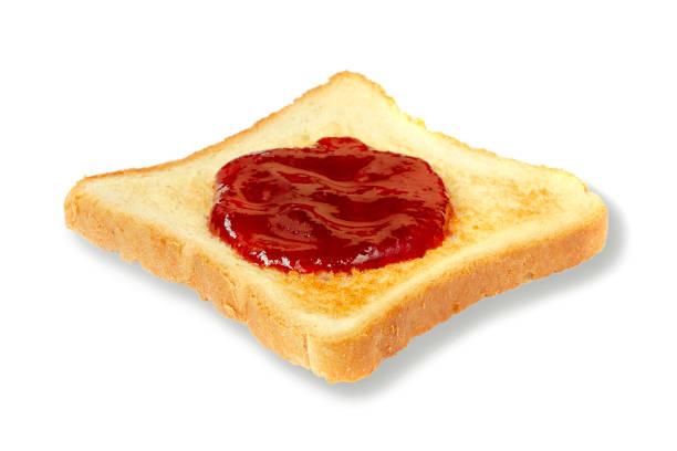 istock Toast with cranberry jam isolated on a white background. Sandwich with white bread and cranberry jam on a white background. Delicious slice of toast with strawberry jam. Toast bread with red jam. 1206859076