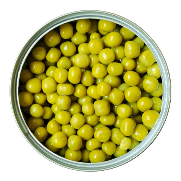 istock Open tin can with green peas on a white background. View from above. Green peas in a jar isolated on a white background. Canned green peas in a jar. 1206859173