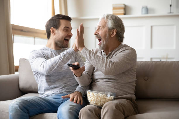 istock Happy young man giving high five to overjoyed father. 1206859211