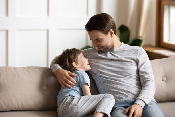 istock Happy young father embracing little kid son, communicating at home. 1206859722