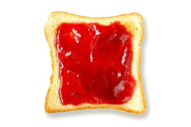 istock Toast with cranberry jam isolated on a white background. Top view. Sandwich with white bread and cranberry jam. Delicious slice of toast with strawberry jam. Toast bread with red jam. 1206860284