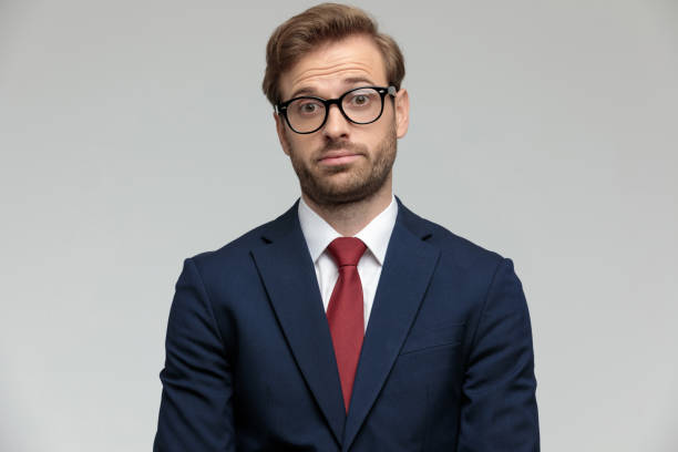 istock businessman standing and looking at camera surprised 1206861657