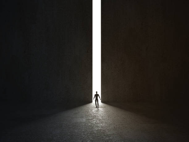 istock Man walking in a narrow light passage. 3D rendering. 1206861770