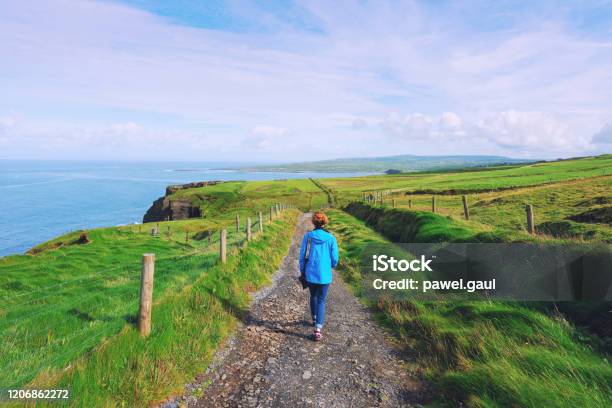 Woman Trekking On Cliffs Of Moher Walking Trail In Ireland Stock Photo - Download Image Now