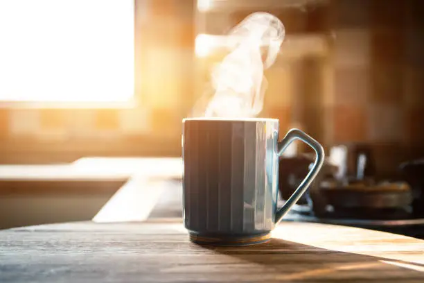 Photo of Hot coffee with steam on table