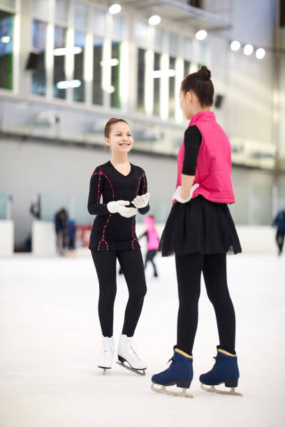 istock Girls Chatting on Ice Rink 1206864084