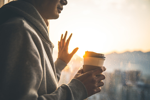 Man drinking coffee in the window