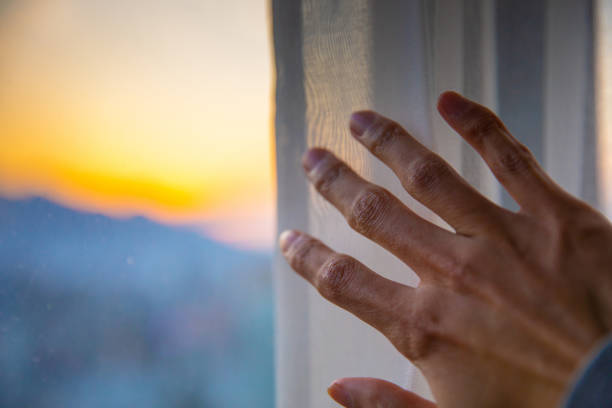 istock Close-up hand open curtan in the morning 1206868490