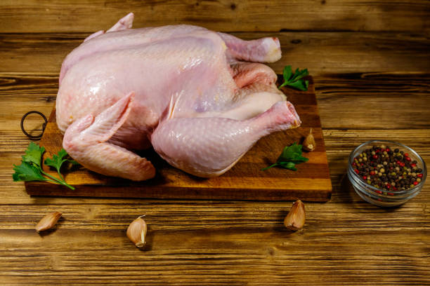 istock Raw whole chicken with spices on a wooden table 1206869983