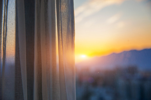 Window with curtain in the morning