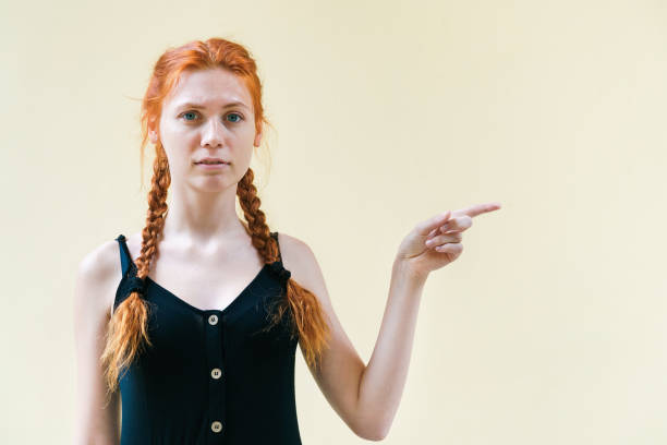 istock Beautiful woman posing on yellow background. 1206874009