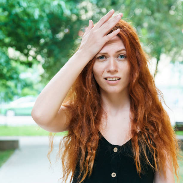 istock Emotional red-haired girl in park. 1206874024