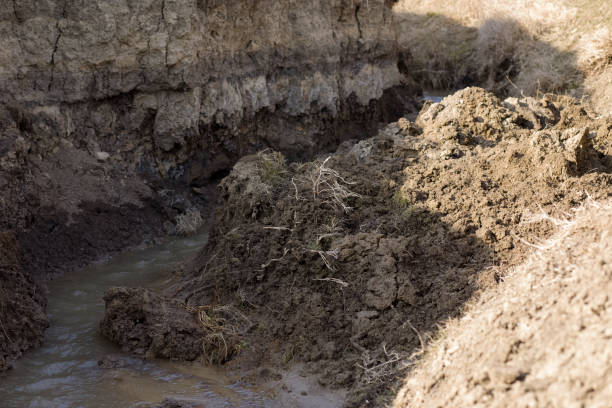 A clay stream draining water causes landslides after heavy rains. Natural environment