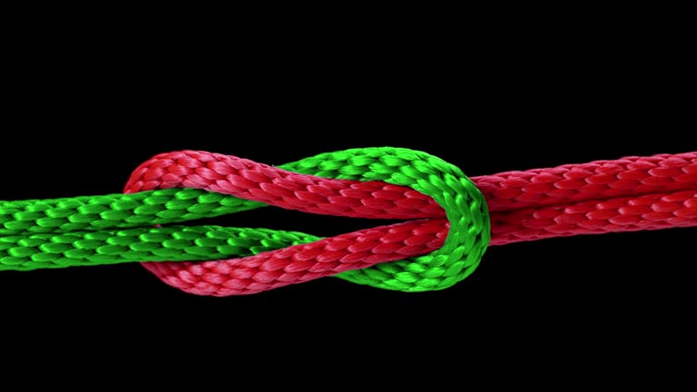 SLO MO LD Knot being tied with a red and green rope