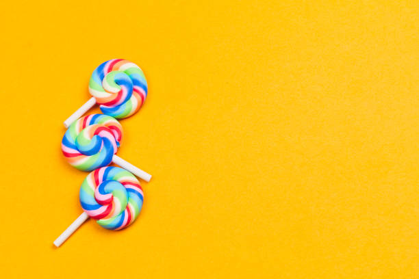 istock Lollipops close up. colorful candies on a yellow background. copy space 1206884456