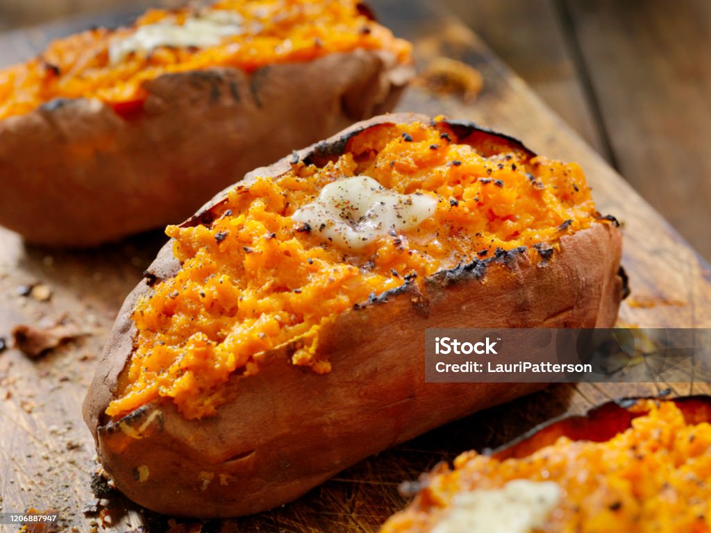 Twice Baked, Stuffed Sweet Potatoes with Melting Butter and Cracked Pepper Sweet Potato Stock Photo