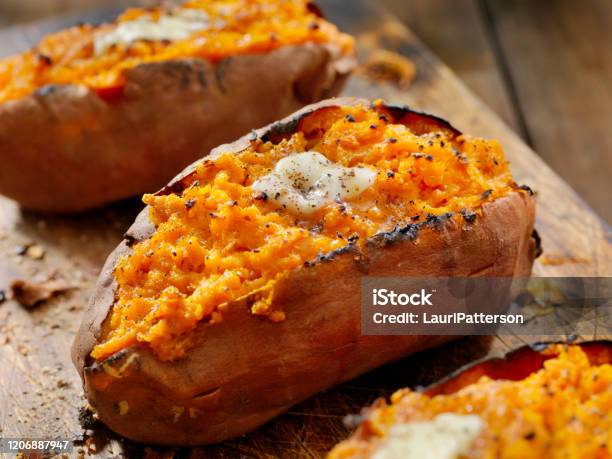 Twice Baked Stuffed Sweet Potatoes With Melting Butter And Cracked Pepper Stock Photo - Download Image Now