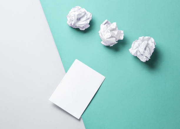 istock Minimalistic business concept. Crumpled paper balls and empty white leaf on a gray-blue background 1206888022