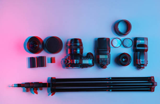 istock Equipment professional photographer. Camera, lenses, flashes, light filters, tripod. Neon light. Glitch effect. Top view 1206889721