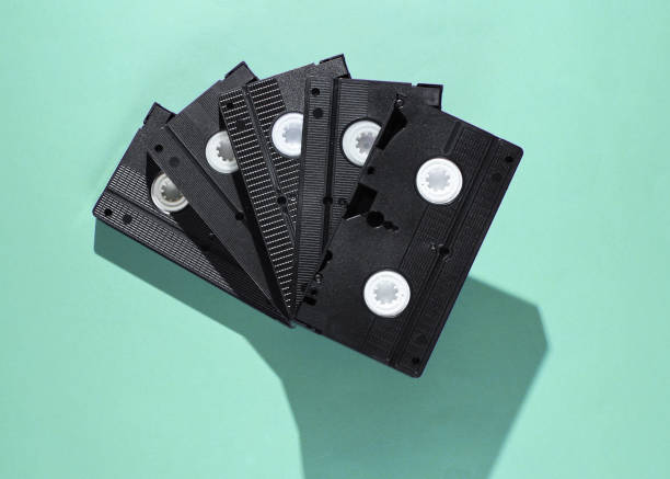 istock Stack of retro video cassettes on blue background. Top view 1206891000