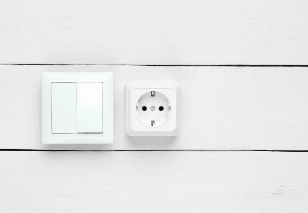 istock Power socket and switch on white wooden wall, minimalism 1206891218