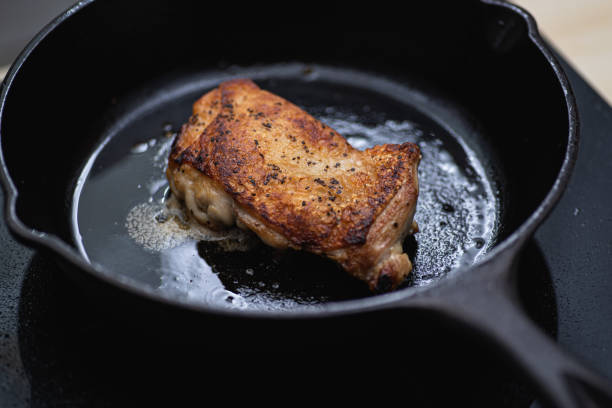 istock Chicken breast with skin on searing on a cast iron skillet. 1206891353