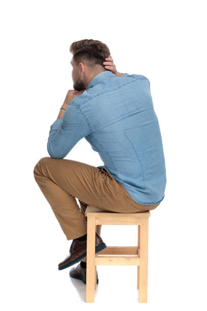 istock thoughtful young man holding hand to chin and thinking 1206891578