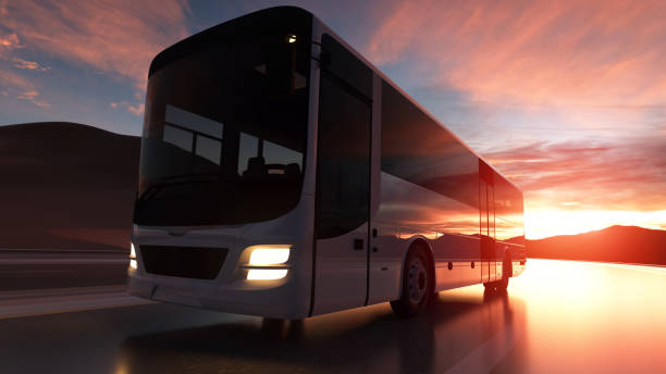 istock Tourist bus driving on a highway at sunset backlit by a bright orange sunburst. 3d rendering 1206891692