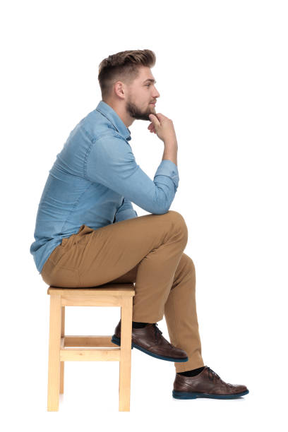 istock thoughtful casual guy holding hand to chin and thinking 1206891762
