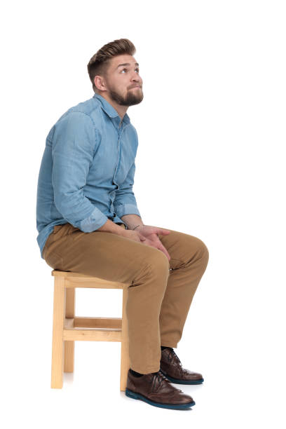 istock cute young guy in denim shirt looking up and praying 1206893223