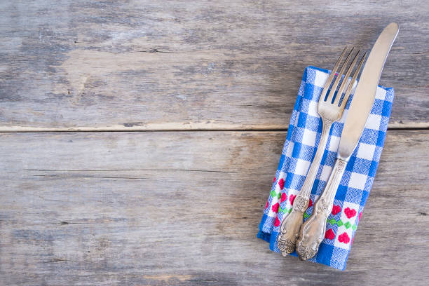 istock Table setting with vintage fork and knife on blue and white checkered napkin 1206893357