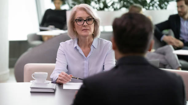 istock Serious middle aged female hr manager conducting interview with applicant. 1206893410
