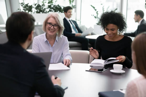 istock Smiling different ages multiracial business people meeting in modern office. 1206893429