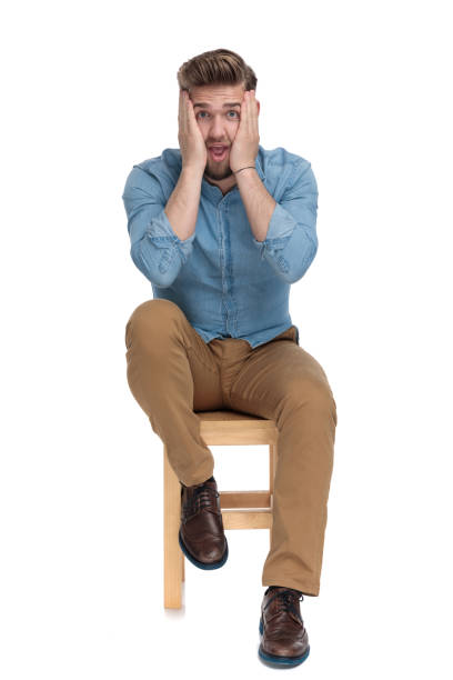 istock young casual man in denim shirt holding hands on face 1206893609