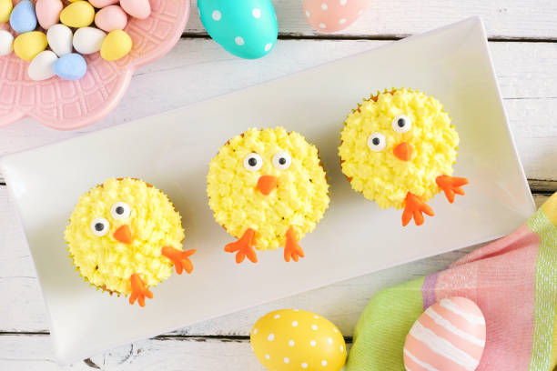 istock Cute Easter chick cupcakes, top view table scene with a white wood background 1206893776