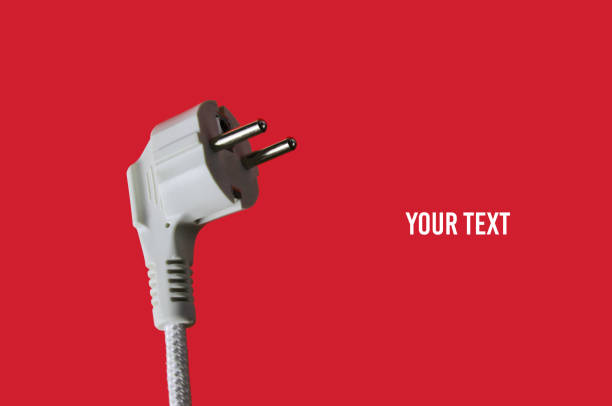 istock Electric plug closeup on red background. Copy space 1206893813
