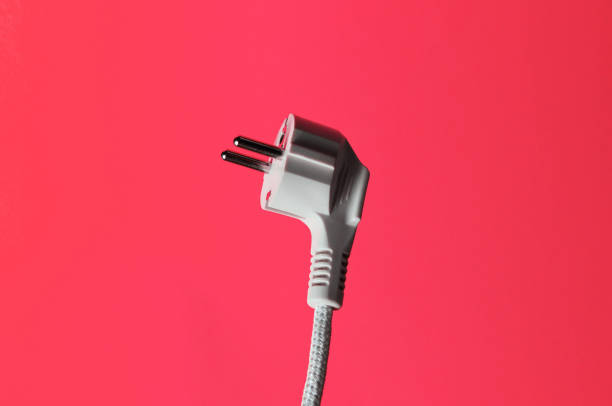 istock Electric plug closeup on pink background 1206893847