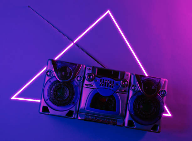 istock Audio cassette recorder with antenna. 80's synth wave and retrowave glowing triangle futuristic aesthetics. Old fashioned abstraction concept 1206894612