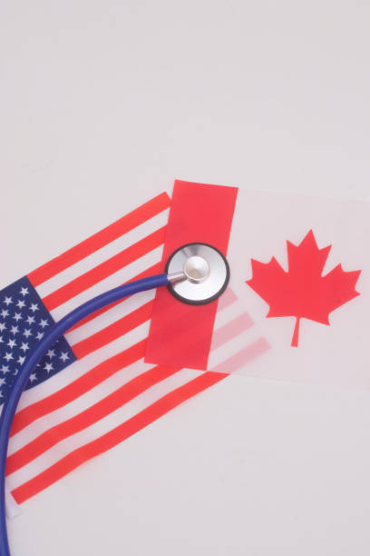 istock Stethoscope over Canadian and USA flag shows discrepancy between these countries concerning health care 1206894876