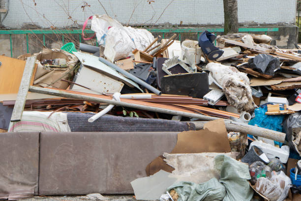 istock Stack of different types of large garbage dump, plastic bags, and trash bins in the courtyard of a residential building. Environmental pollution and public space 1206894929