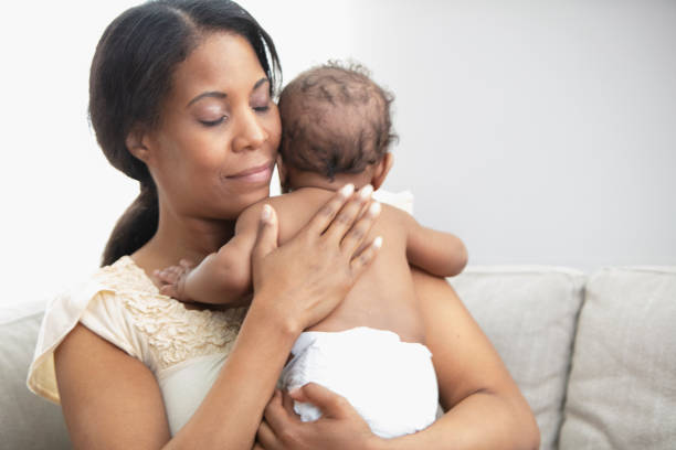 istock Mother holding her sleeping daughter 1206896957