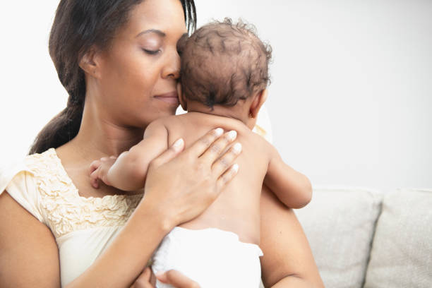 istock Mother holding her sleeping daughter 1206896971