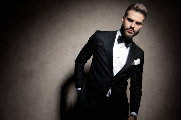 istock dramatic elegant young model in tuxedo posing in a fashion light 1206896988