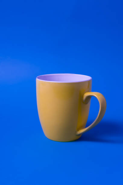 istock Yellow color big mug over blue background. 1206897062