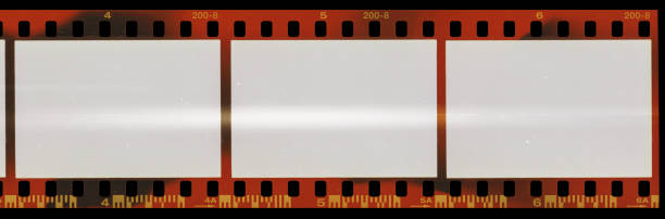 istock real scan of long 35mm film negative material with cool scanning light interferences on the material. 1206897828